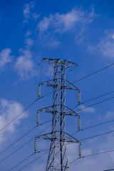 Electrical tower station wiring power with cloudy and blue sky background, High voltage station post