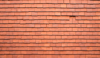 Old orange square tiles. Home roof, textured background with beautifully lined top view.