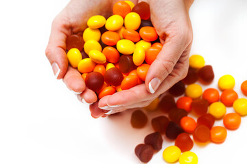 Female hands holding vitamins on white background