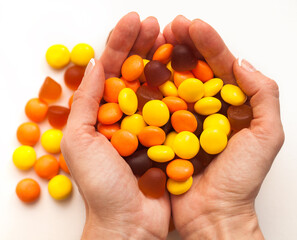 Female hands holding vitamins on white background