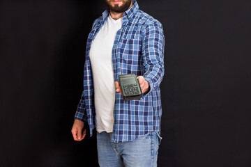 Man holds a wireless payment terminal in his hand. Providing customers with a more convenient way to make payments