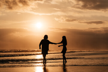 Fototapeta premium Young couple in love, Attractive man and woman enjoying romantic evening on sunset