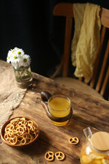 Cookies, fruit tea on a wooden table, a chair in the background.