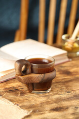 Beautiful cup of coffee on a wooden table.

