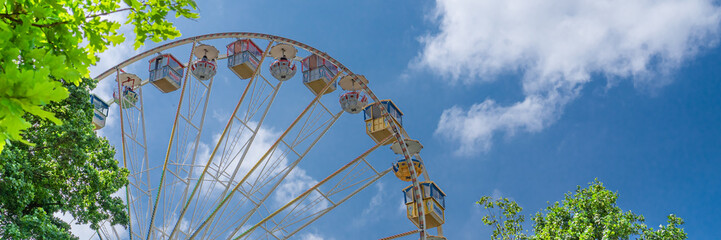 A beautiful old ferris wheel with blue sky background, banner - obrazy, fototapety, plakaty