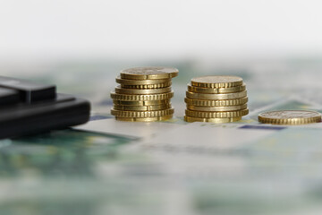 Euro banknotes with a calculator and coins. Business concept