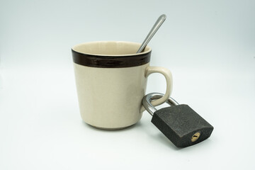 A coffee cup locked with paddle lock on white background.  drinking concept.