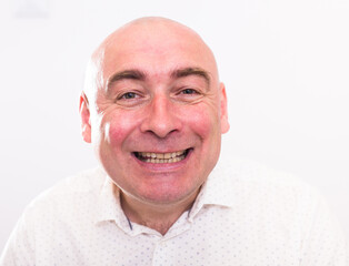 portrait of bald adult elderly man with emotions on white background