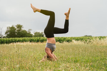 smiling blonde girl does physical exercises outdoors