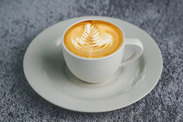 hot espresso and coffee bean on white concrete table with soft-focus and over light in the background. top view with copyspace for your text