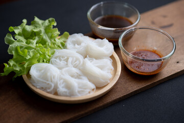 Thai Dried Rice Noodles  in wooden bowl with ingredients for delivery