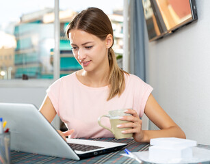 Female using laptop at home