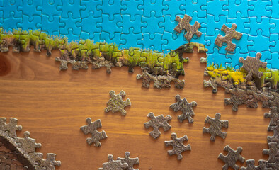 Game - puzzles scattered on a wooden table top.