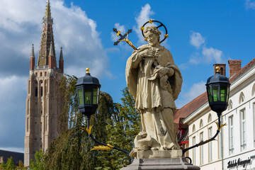 Fototapeta na wymiar Statue of St.John of Nepomuk, on Wollestraat Bridge in Bruges, Belgium