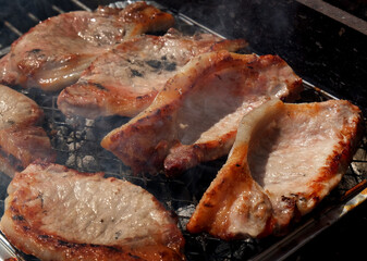 Barbecue cooking in an urban house garden in summer weather. UK.