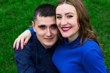 Fototapeta premium loving man and beautiful young pregnant woman looking at each other outdoors