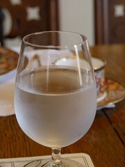Cold water in a stem glass, with steam outside the glass
