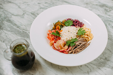 ingredients for cooking Korean kuksi in a white plate on a marble table