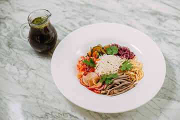 ingredients for cooking Korean kuksi in a white plate on a marble table