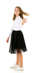 A little girl fixes her hair.The concept of beauty and fashion