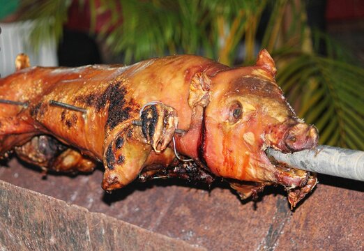 Lechon baboy is when the pig is cooked slowly over charcoal and rotated by hand on a bamboo spit.
