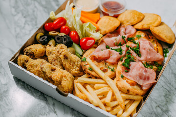 cold cuts with vegetables on a marble table