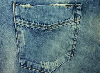 Pocket on blue jeans trousers as background. Close-up