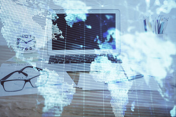 Double exposure of business theme icons and work space with computer background. Concept of success.