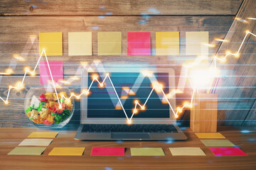 Multi exposure of graph and financial info and work space with computer background. Concept of...