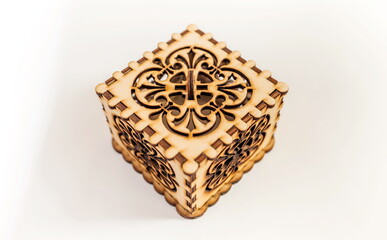 The box is made of plywood with a pattern cut by laser cutting on a white background