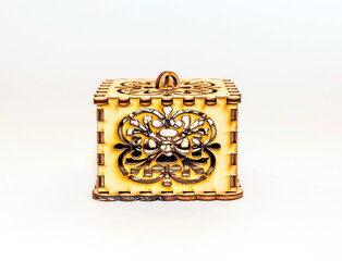 The box is made of plywood with a pattern cut by laser cutting on a white background