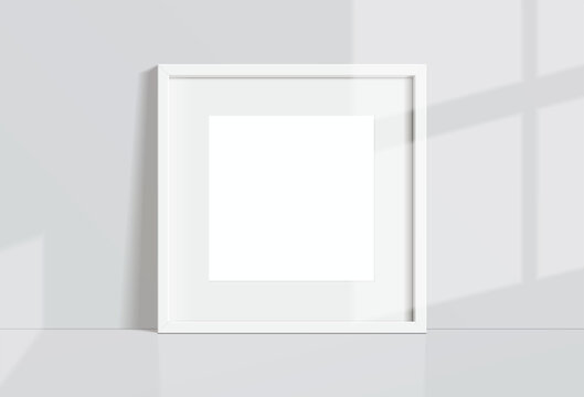 Minimal empty square white frame picture mock up hanging on white wall background with window light and shadow. isolate vector illustration.