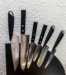 Kitchen knives on a magnetic stand against the wall