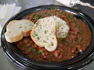 Plate of spicy chicken red beans topped with garlic bread