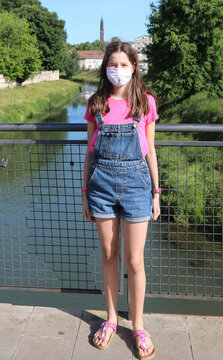 Little with with jeans and surgical mask