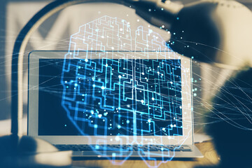 Double exposure of desktop computer and human brain drawing hologram. Ai concept.