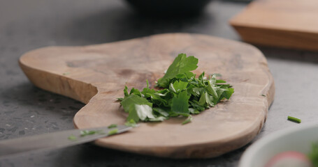 fresh chopped parsley on olive board