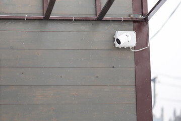 External CCTV camera on the wall of a building background with copy space.