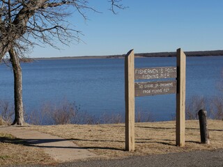Wooden sign of Fishermen’s Point fishing pier beside Lake Thunderbird