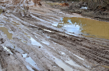 Broken dirt road after heavy rain. Swampy lagoon of a road demonstrates the most common problem in maintaining rural roads