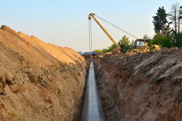 Natural gas pipeline construction work. A dug trench in the ground for the installation and...