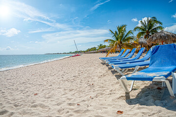 Obraz na płótnie Canvas Deck chairs on a tropical beach of the caribbean sea
