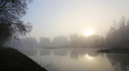 foggy winter sunrise on riverside skyline