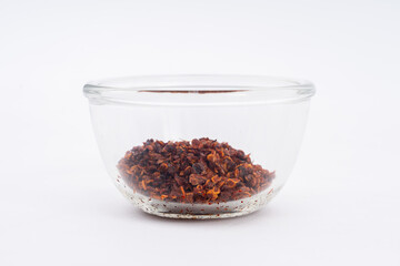 Chilli, red chilli flakes, dried chillies flakes in glass cup on a white background 