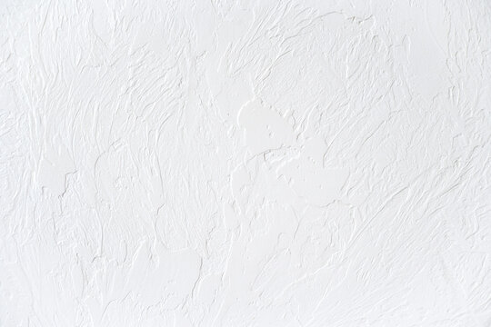 The texture of the white concrete table. White painted texture with brush and palette knife strokes for interesting and modern backgrounds.