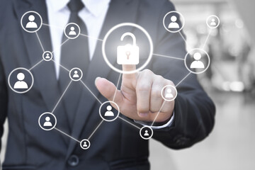 Businessman hand pressing unlock icon on virtual screen for network connection. Concept of global communication in business.