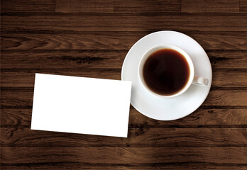 Obraz na płótnie Canvas cup of coffee with blank card on wooden table