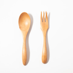 Close up wooden spoon and fork on white background
