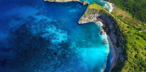 Aerial view at sea and rocks. Blue water background from top view. Summer seascape from air. Nusa Penida, Bali, Indonesia. Travel - image