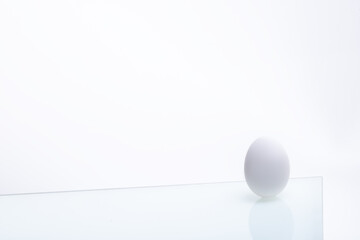 fresh white chicken eggs on glass isolated on white background